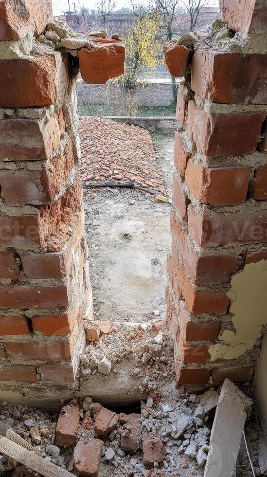 Crumbling Brick Wall A Detailed Study of Architectural Decay, Revealing Raw Textures, Historic Masonry, and Urban Abandonment. photo