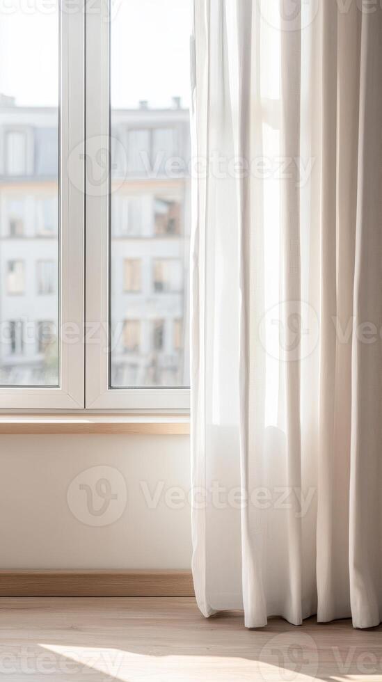 Serene morning light bathes a modern minimalist interior, highlighting sheer white curtains and a window overlooking a tranquil urban cityscape, evoking peaceful domestic comfort. photo