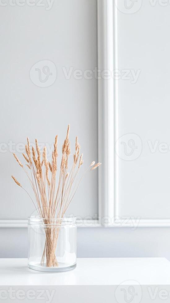 Elegant Dried Grass in Clear Vase Minimalist Natural Home Decor Accent for Serene Interiors. Perfect for Modern Aesthetic Spaces and Subtle Beauty photo