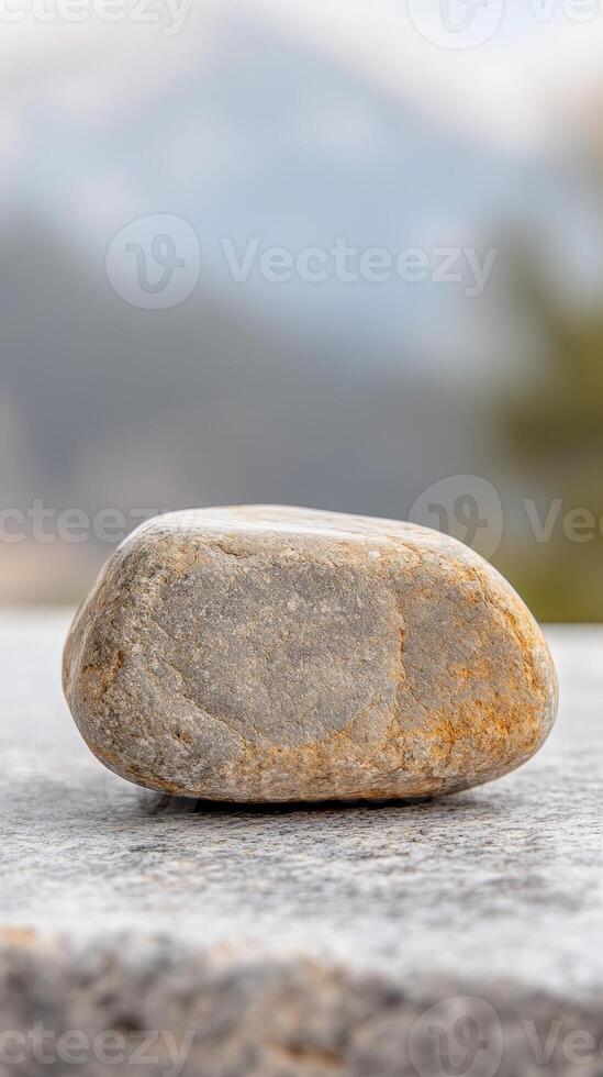 A captivating natural stone, weathered and smooth, rests serenely on a textured surface, embodying tranquility and the enduring beauty of the earth's elements. photo