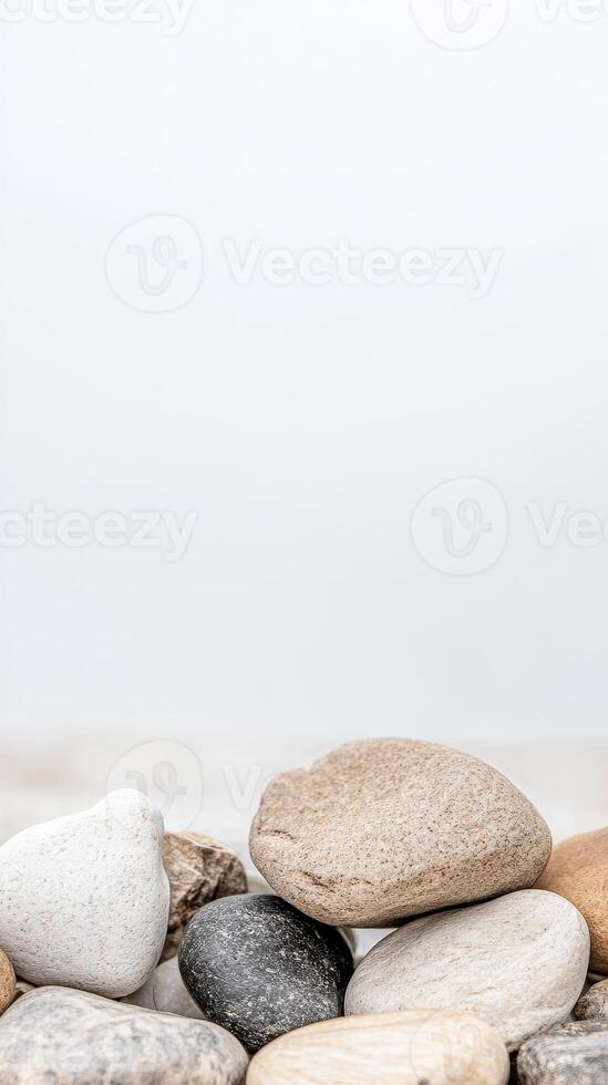 Artful Arrangement of Smooth River Stones and Pebbles in Natural Hues, Perfect for Tranquil Zen Decor, Spa Concepts, or Organic Backgrounds photo