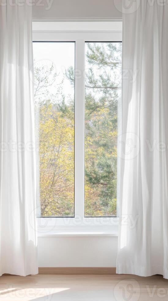 Bright, Minimalist Room with White Curtains and Hardwood Floor, Offering a Serene View of Golden Autumn Trees and Lush Greenery through a Window. photo