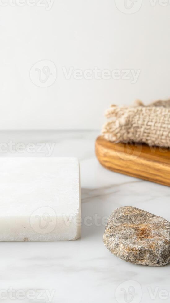 Natural Spa Essentials Serene Marble Surface with Organic Soap, Smooth Stone, and Textured Loofah on a Wooden Tray for Wellness and Self-Care. photo