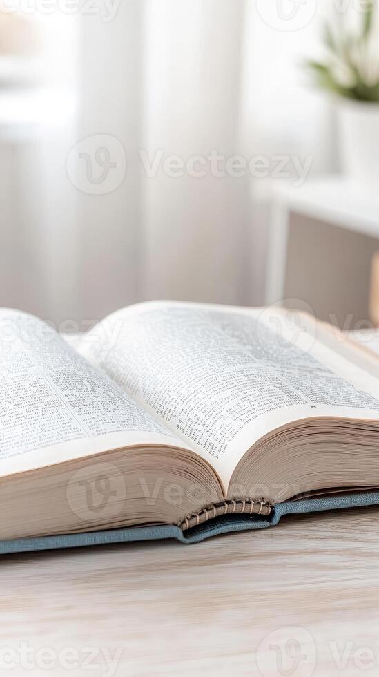 Open book resting on a light wooden table, its pages filled with text, bathed in soft natural light, symbolizing knowledge, quiet study, and the joy of reading. photo