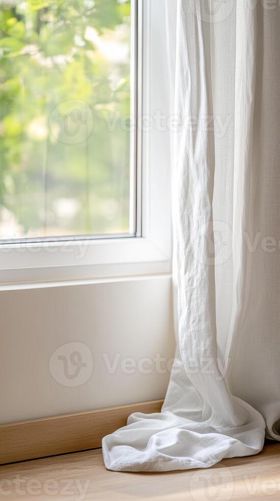 Bright natural light streams through a modern window, illuminating a soft white linen curtain cascading onto a warm wooden floor, creating a serene and inviting domestic interior space. photo