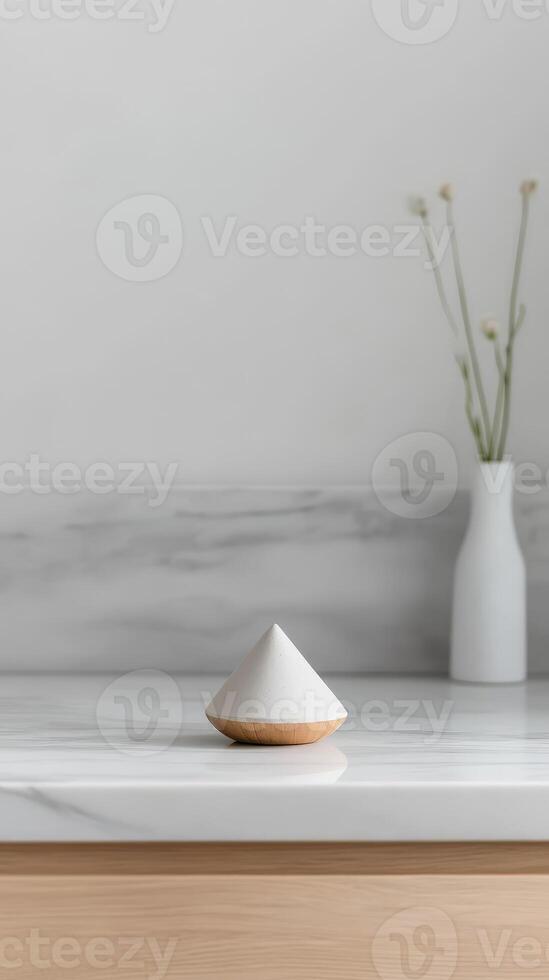 Elegant minimalist home decor, featuring a modern white and wood geometric object on a pristine marble counter, creating a serene and clean interior aesthetic. photo