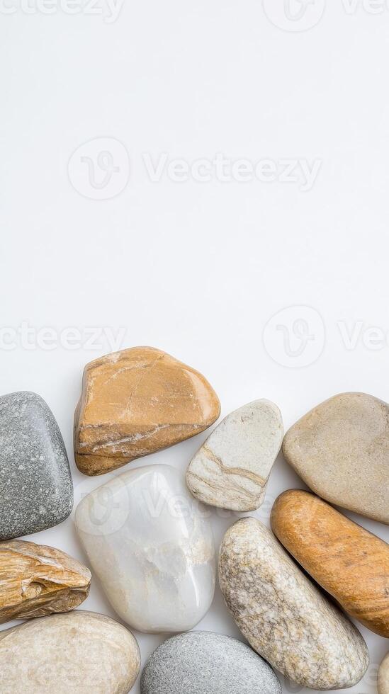 A serene composition of smooth, natural river stones and pebbles, showcasing earthy textures and calming hues on a pristine white background. photo