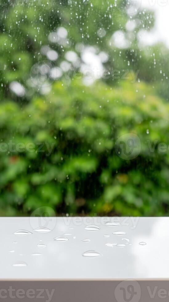 Serene Raindrops on a Pristine White Surface with a Lush Green Bokeh Background photo