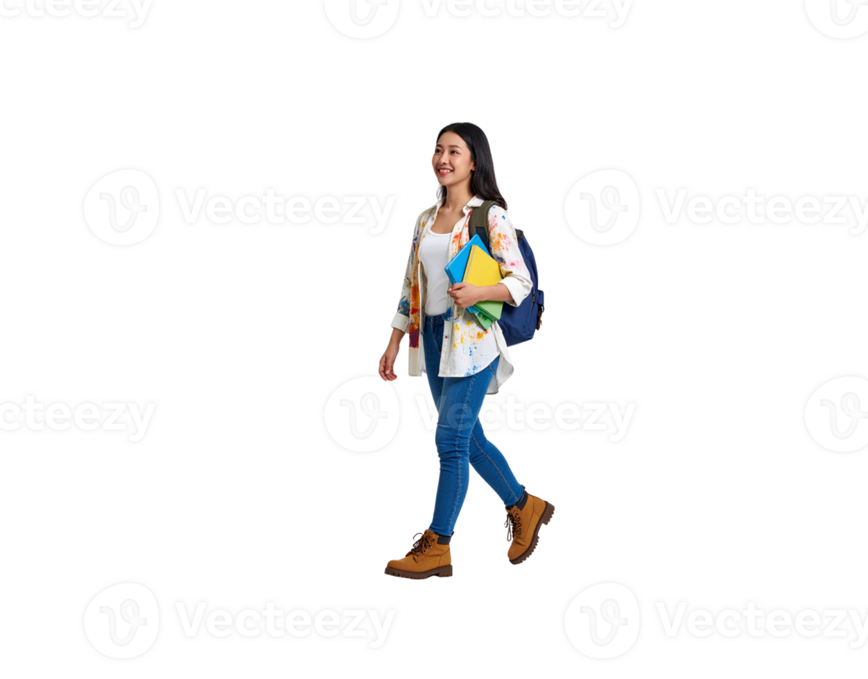 Happy young Asian female art student walking with books wearing a paintsplattered shirt and boots. png