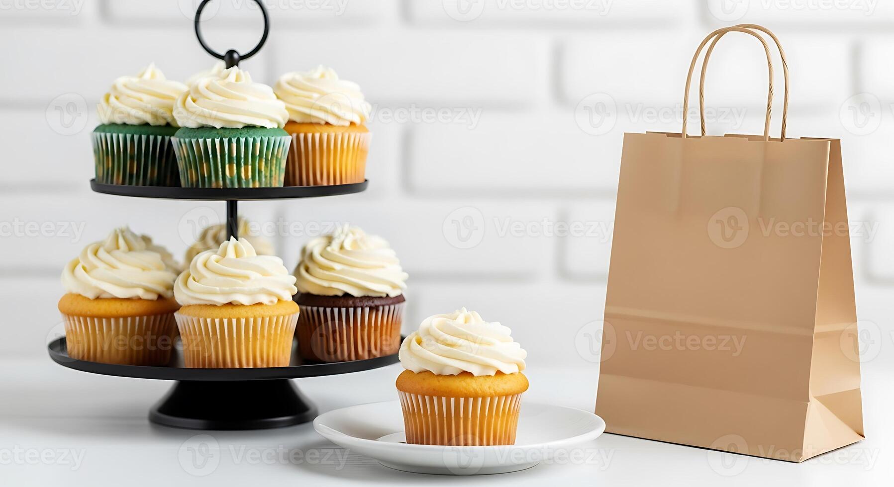 Assortment of cupcakes on a tiered stand with a gift bag photo