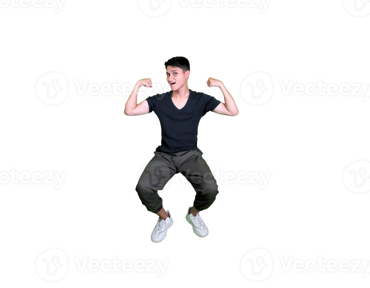 A young man dressed casually poses happily sitting while showing off his arm muscles. png