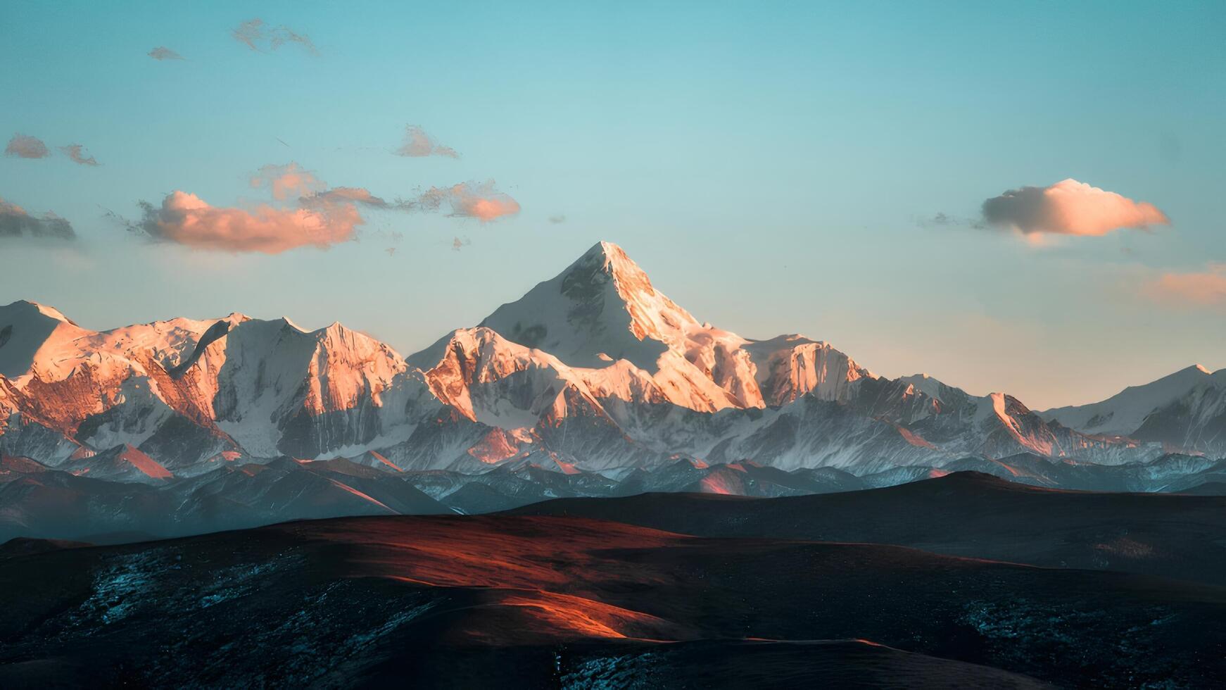 Majestic Snow Covered Mountain Peak at Sunset photo