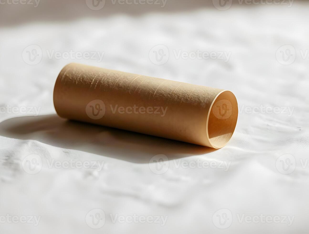 A rolled up piece of paper sitting on a white surface photo