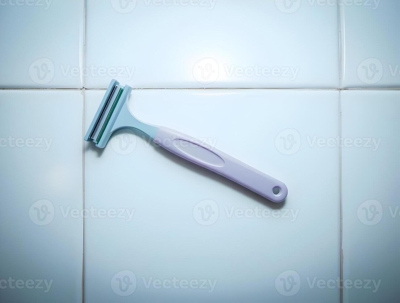 A razor is sitting on a tiled floor photo