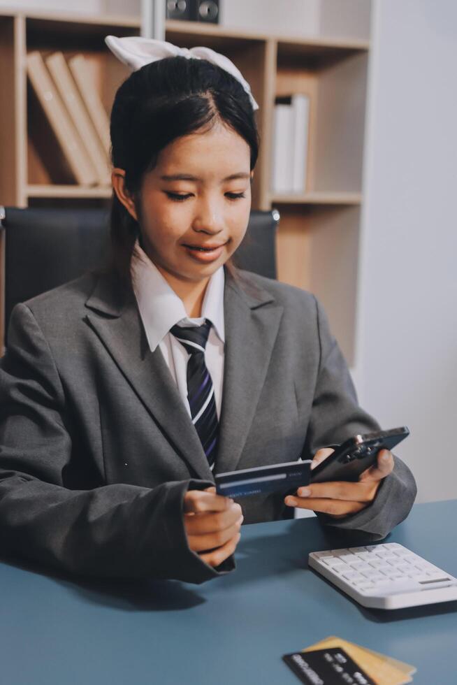 Asian female student using tablet computer at office photo