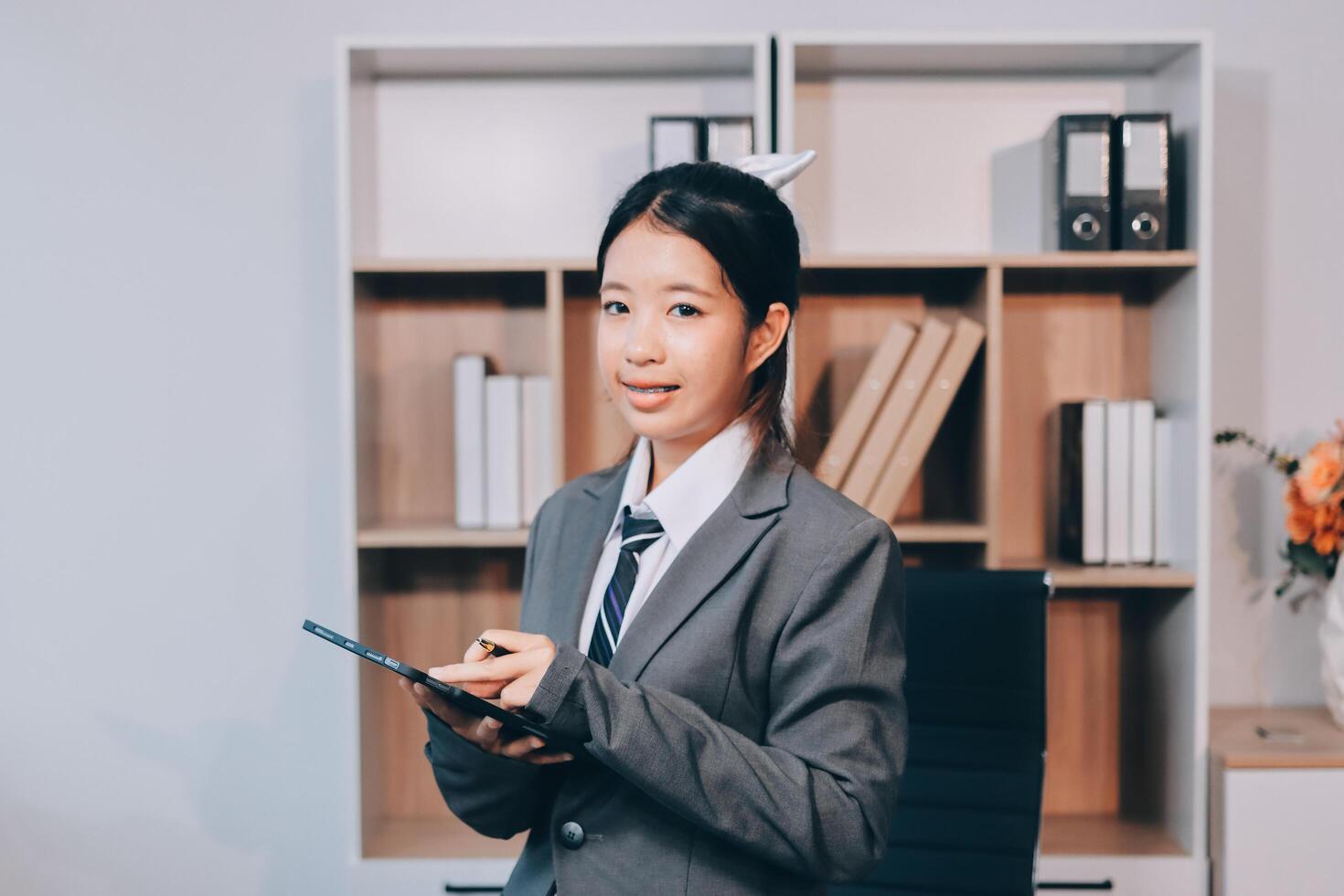 Asian business woman in office with tablet photo