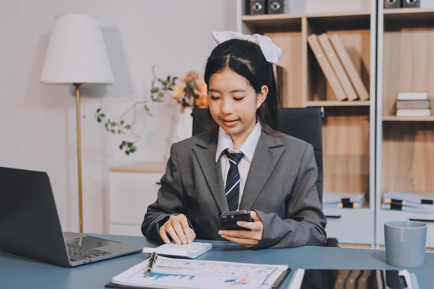 Asian business woman in office using her phone photo