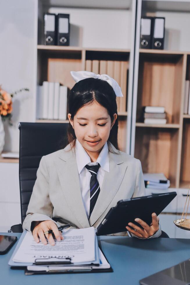 Asian female lawyer working in office with tablet pc photo