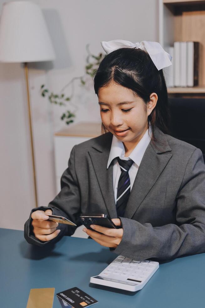 Asian girl in business suit using credit card photo