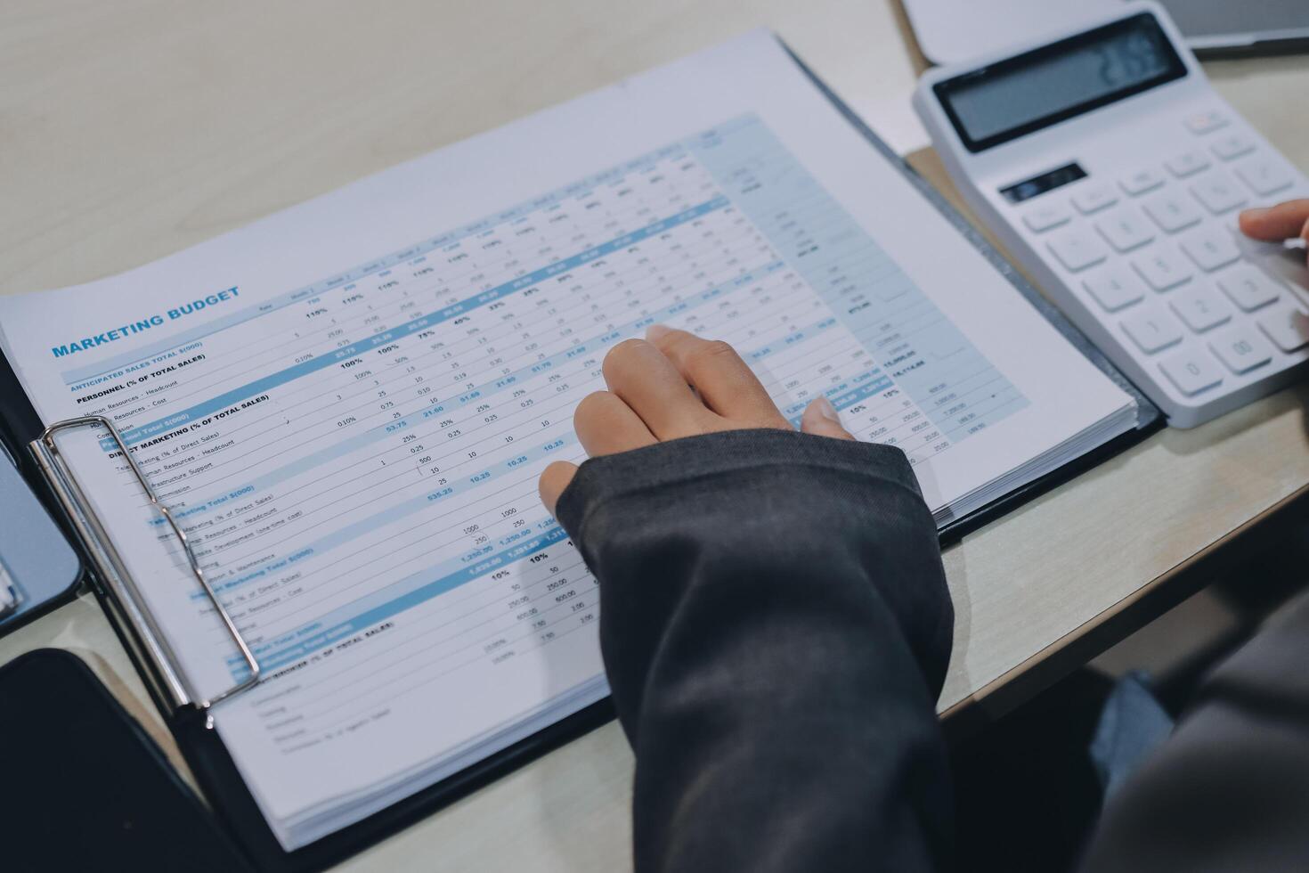 Businessman using calculator to calculate the financial report photo