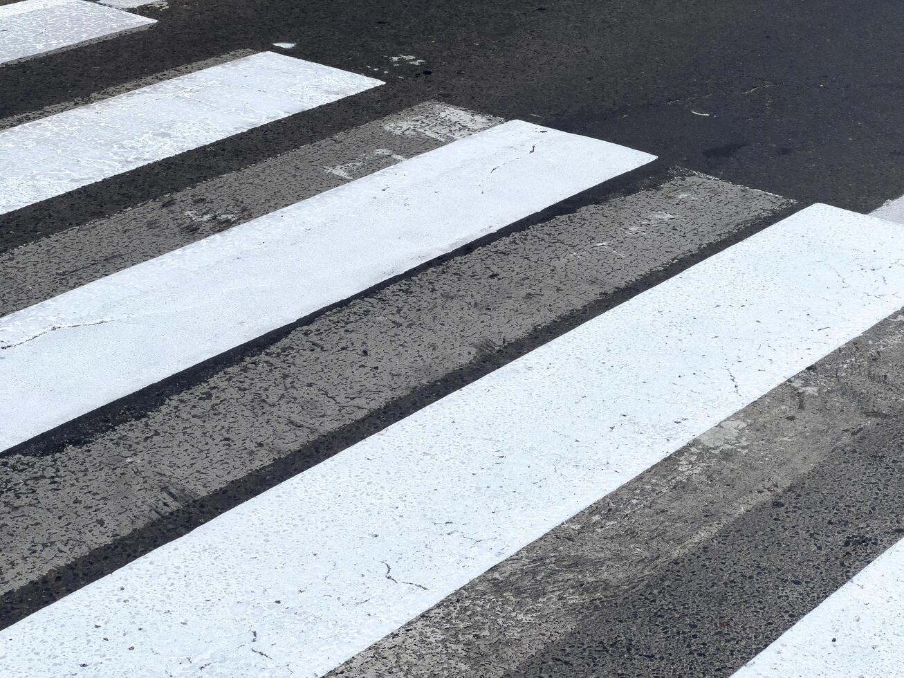 Freshly painted crosswalk lines create a striking contrast against the asphalt, enhancing pedestrian safety on the street photo