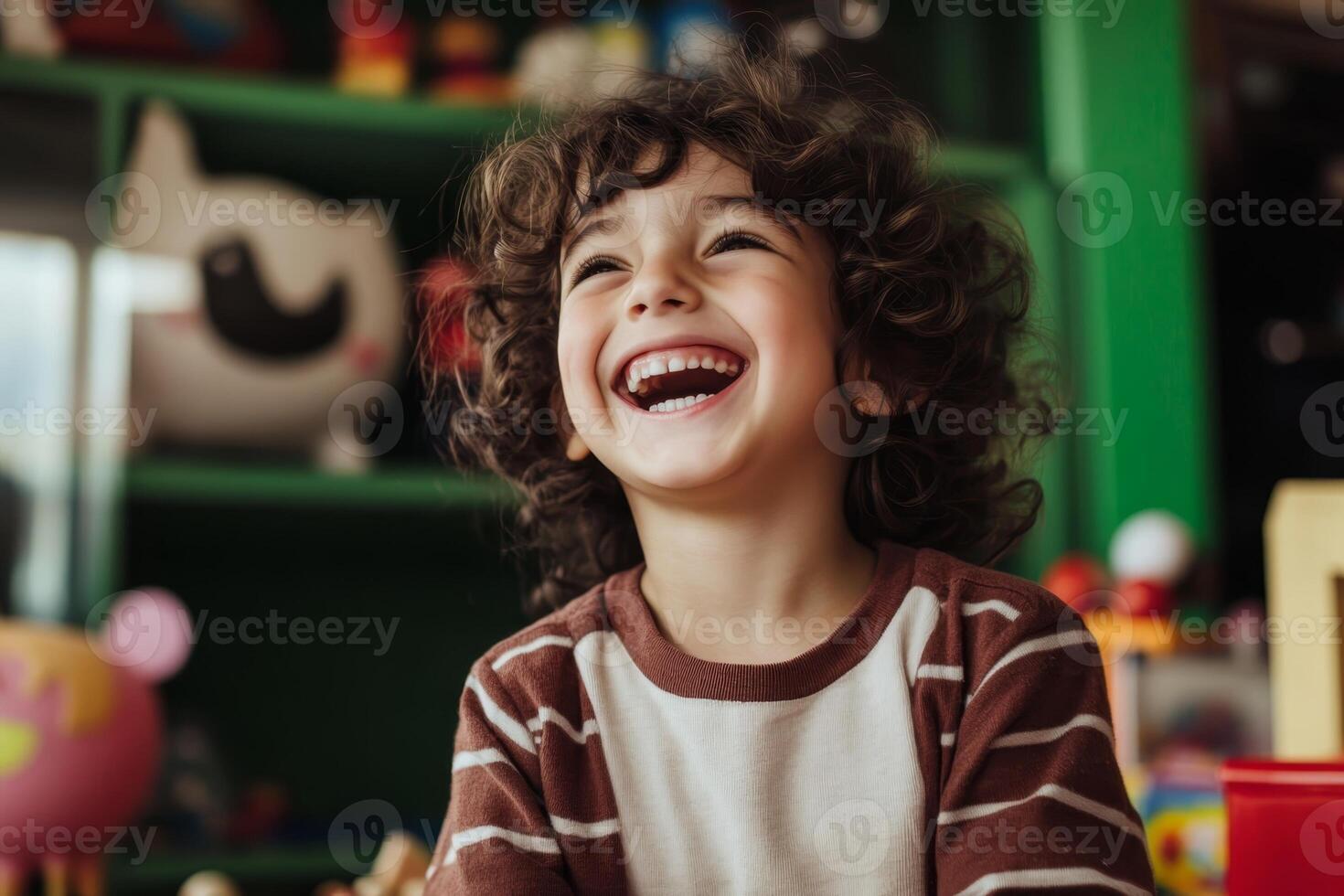 Happy child with curly hair laughs joyfully while playing in a colorful toy room during the afternoon photo