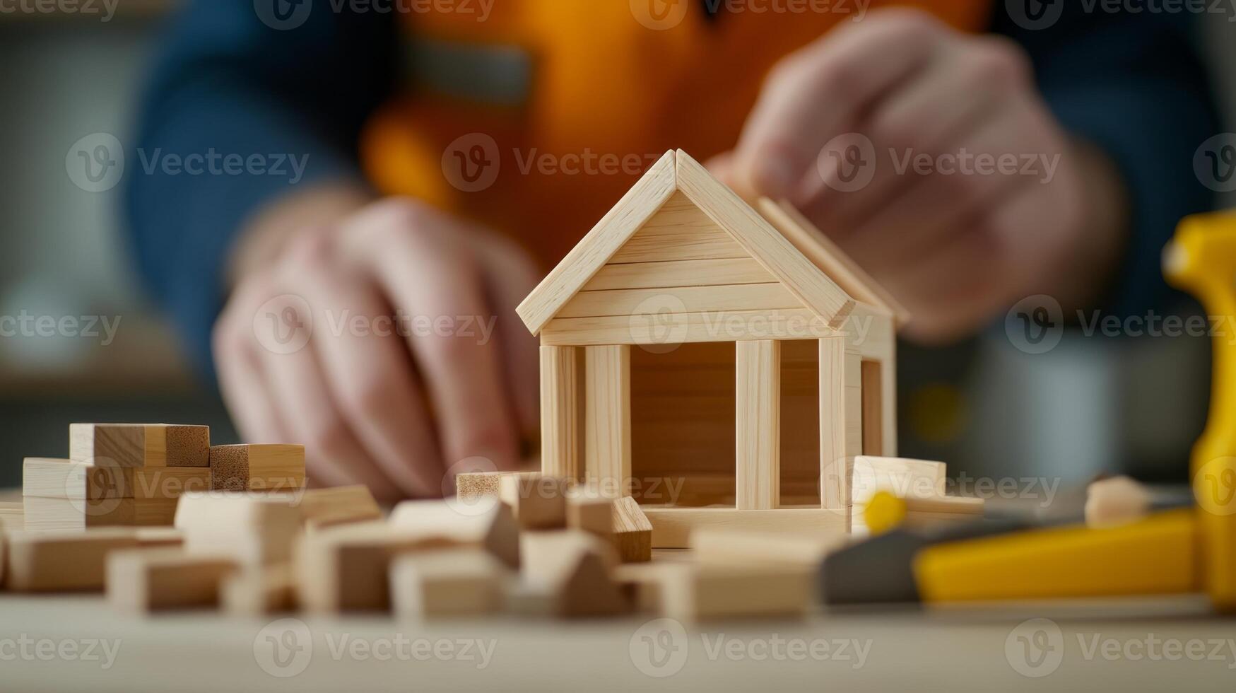 Crafting a miniature wooden house with care and precision in a workshop setting during daylight hours photo