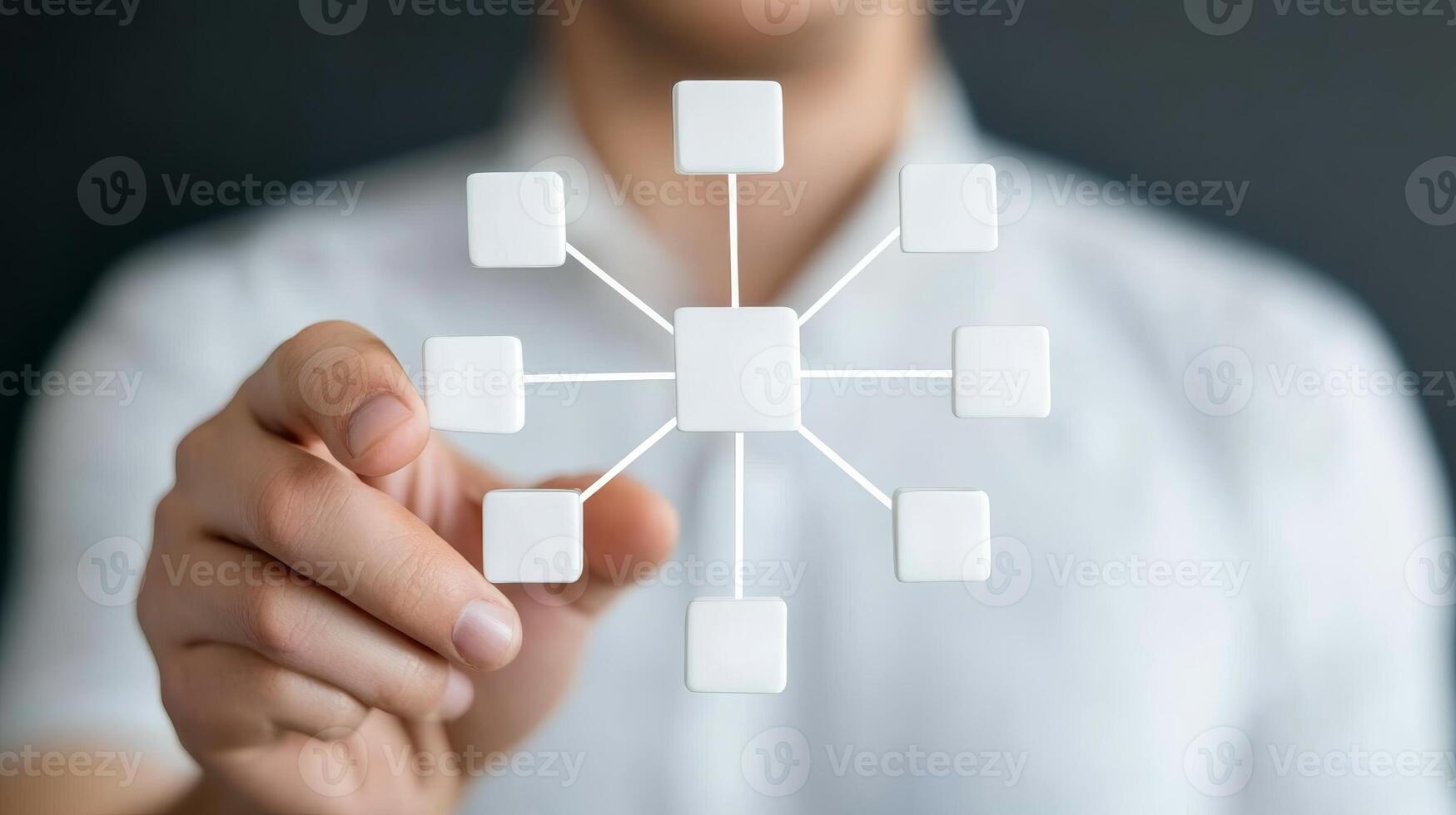 Person holding a complex flowchart design featuring blank white rectangles and lines against a dark background in an office setting photo