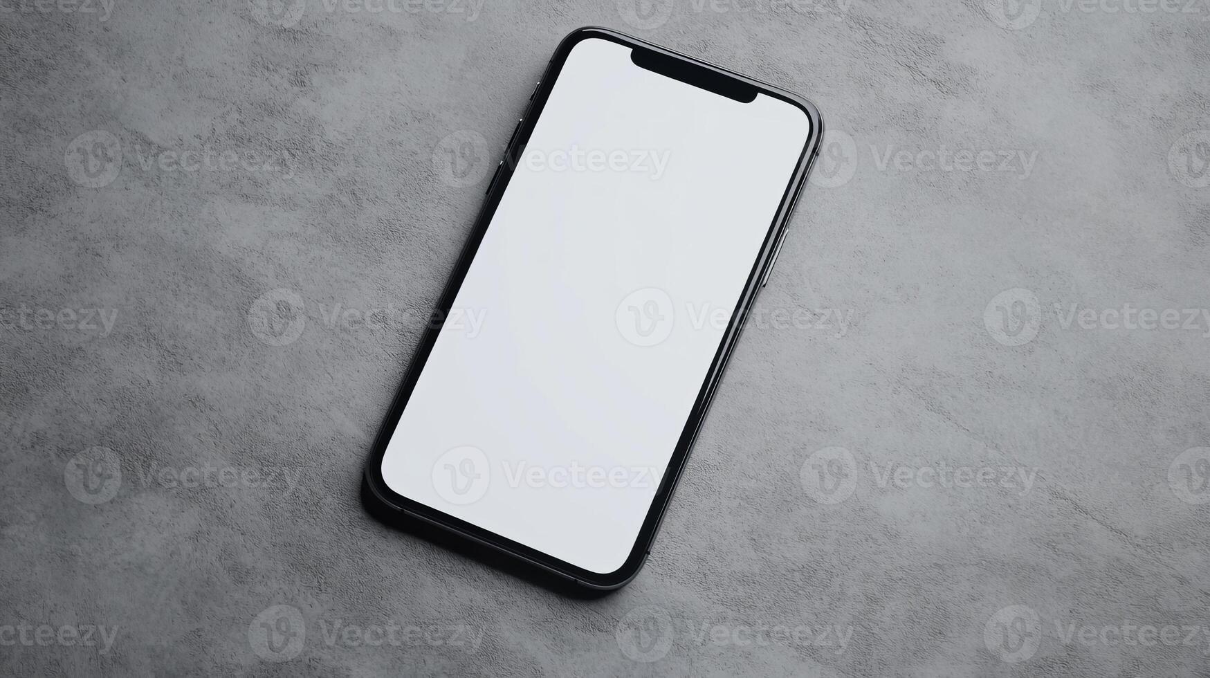 Smartphone with blank screen on a textured gray surface, showcasing modern technology and minimalistic design in an indoor setting photo