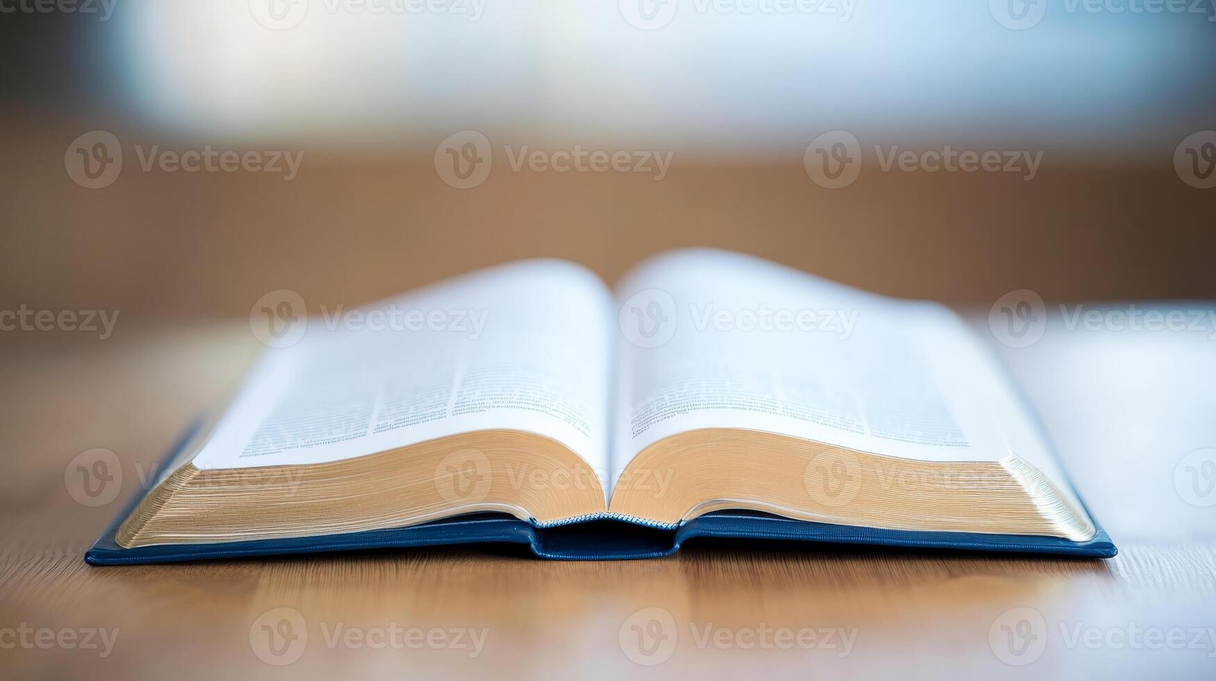 Open book with pages fanned on a wooden table, showcasing knowledge and literacy in a serene setting photo