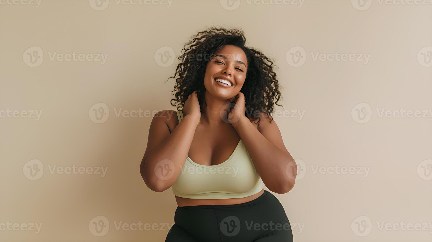 Plus size black woman smiling and touching her neck photo