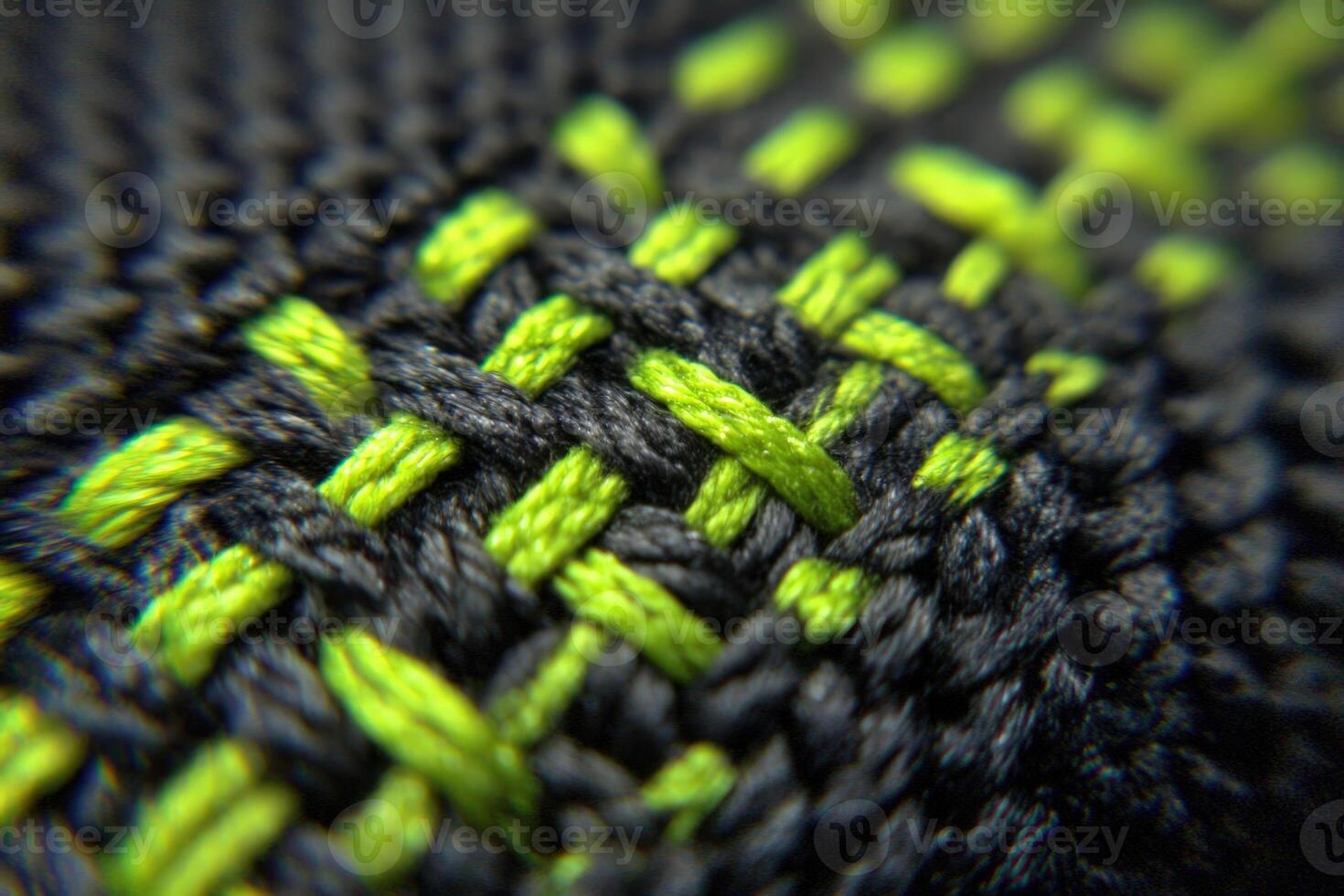 Close up of Cordura fabric showcasing detailed bartack stitching with vibrant green and black thread patterns photo