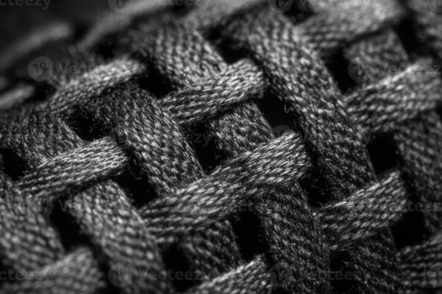 Close look at a textured black and white cord material emphasizing intricate woven patterns photo