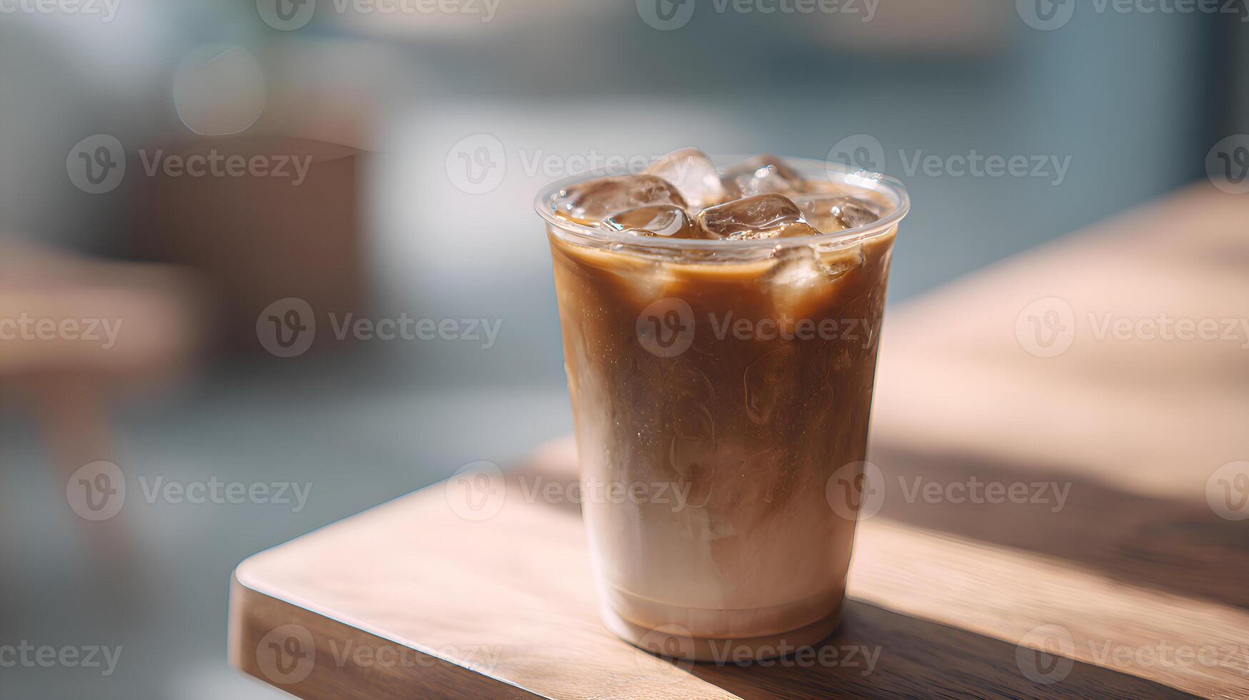 Iced latte resting on a wooden table in a cafe, illuminated by natural light photo