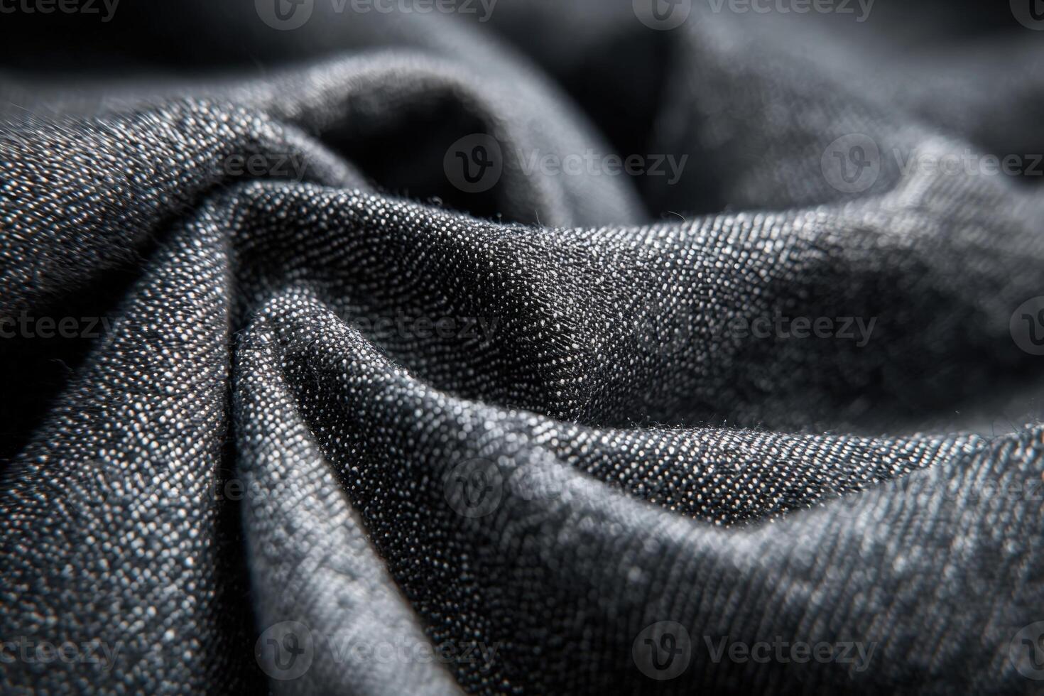 Charcoal denim fabric showcasing intricate texture and deep color details in a close up shot photo