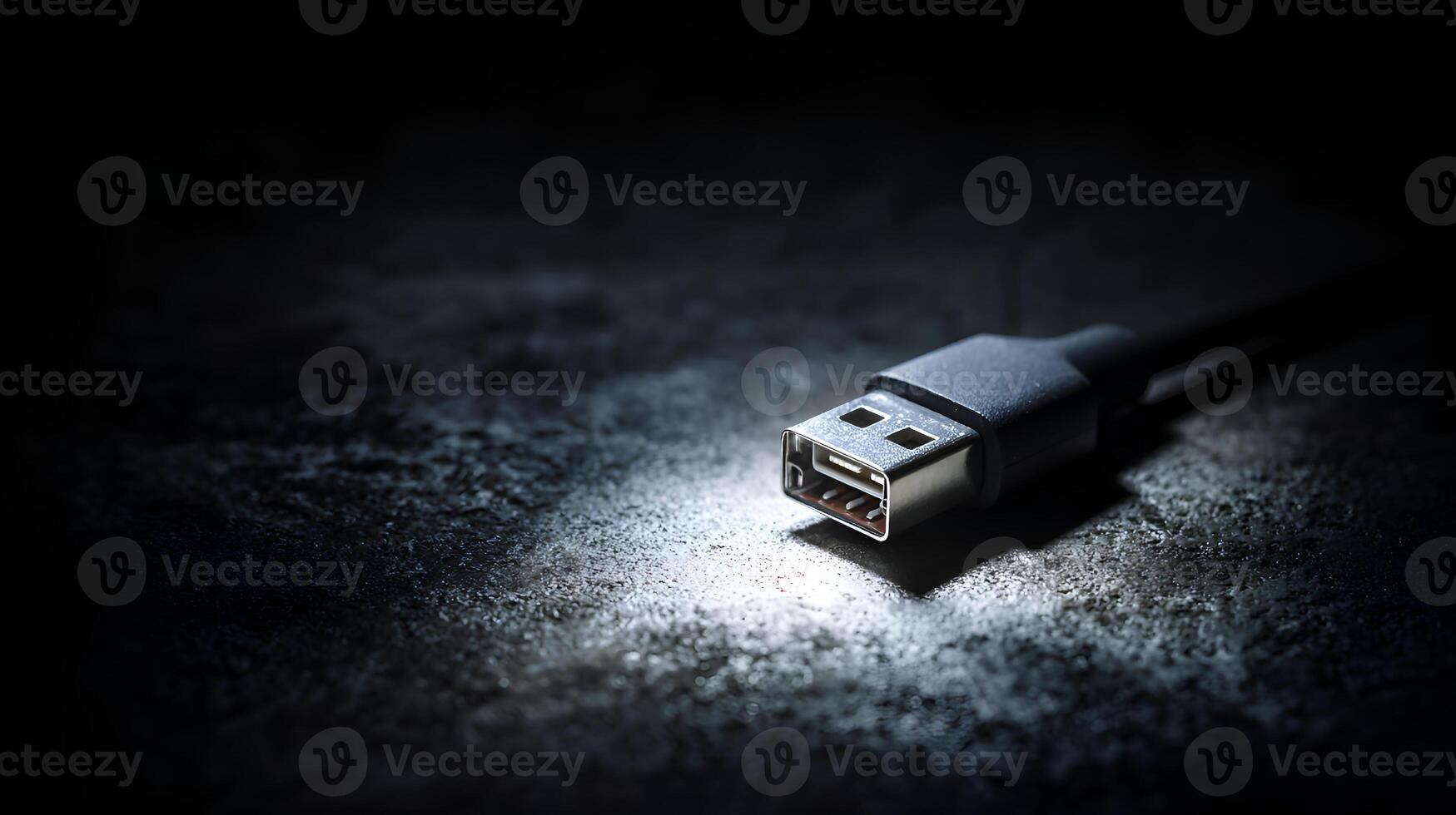 Usb cable lying on dark background emitting light photo