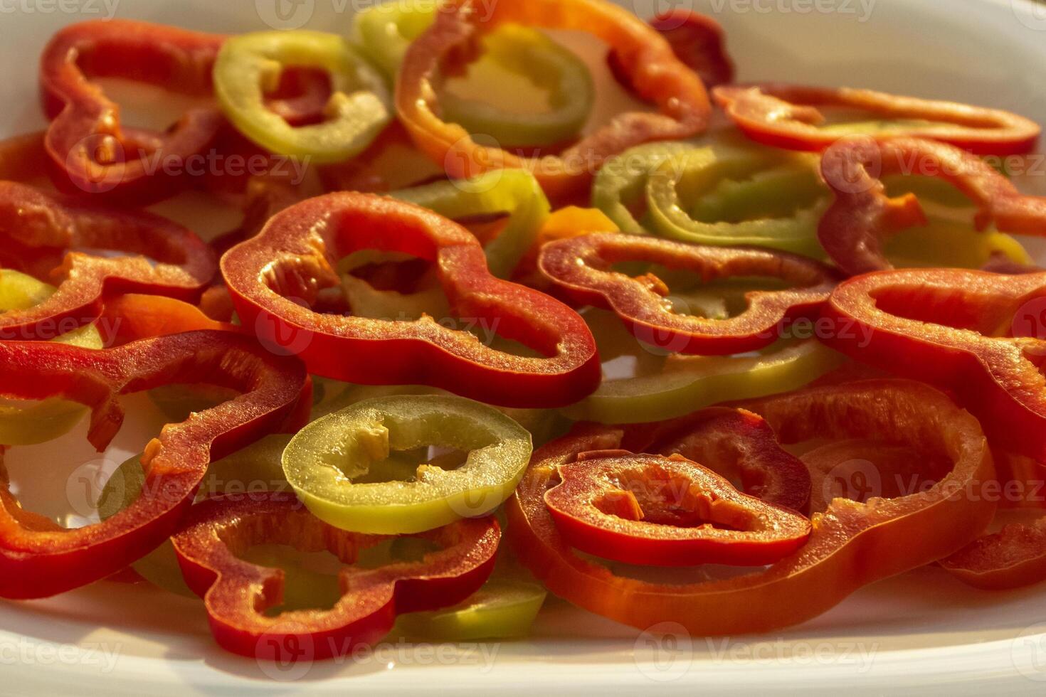 Salad made of raw pepper rings. Sweet red and green pepper. Selective focus. photo
