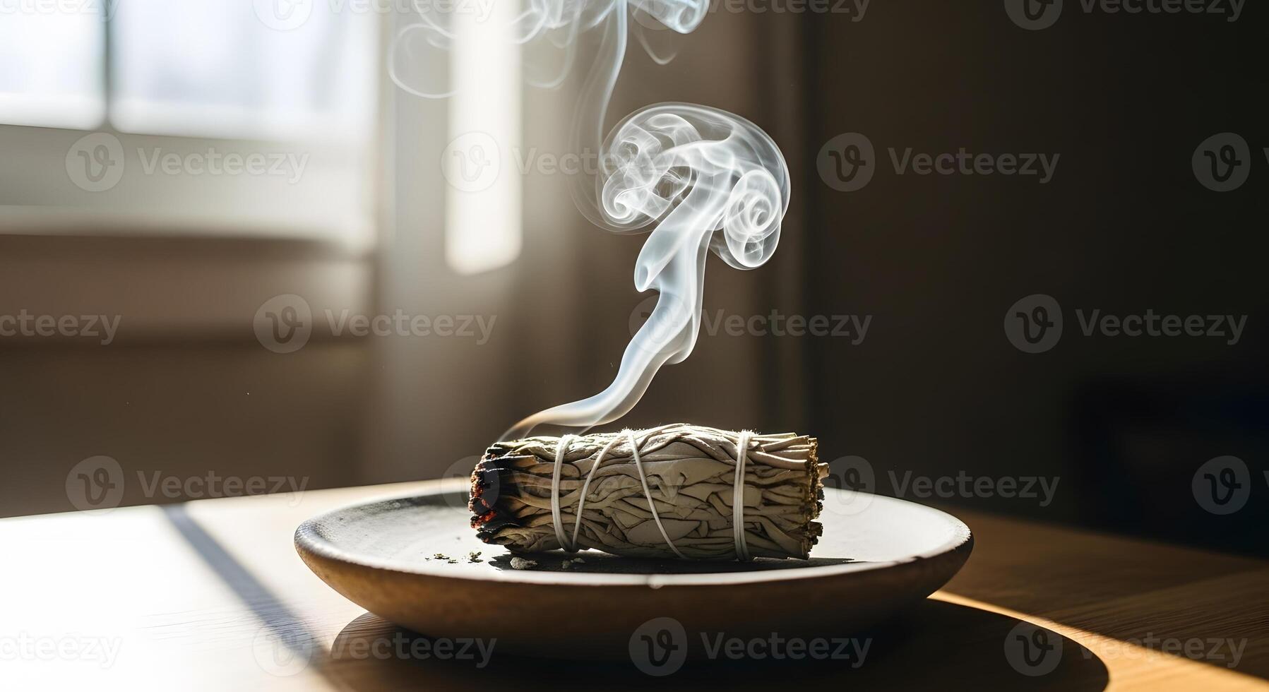Smoke rising from a bowl of incense on a table photo