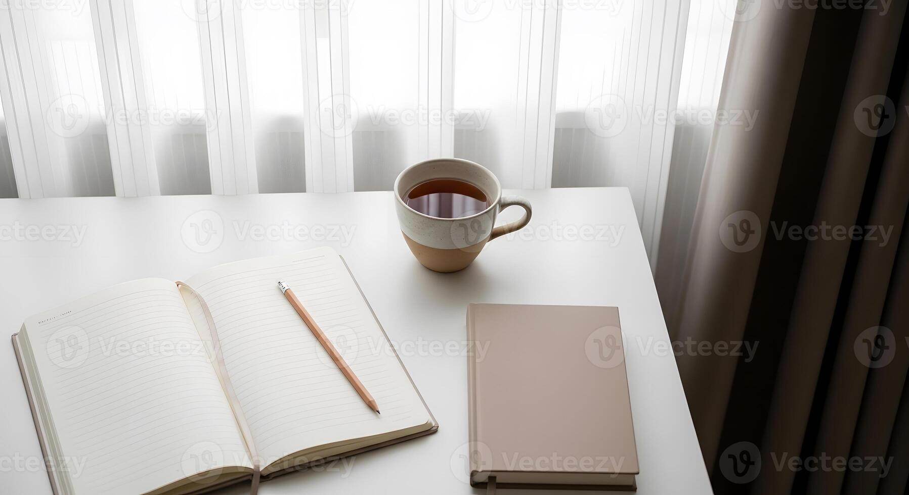 A cup of coffee and a notebook on a white table with curtains photo
