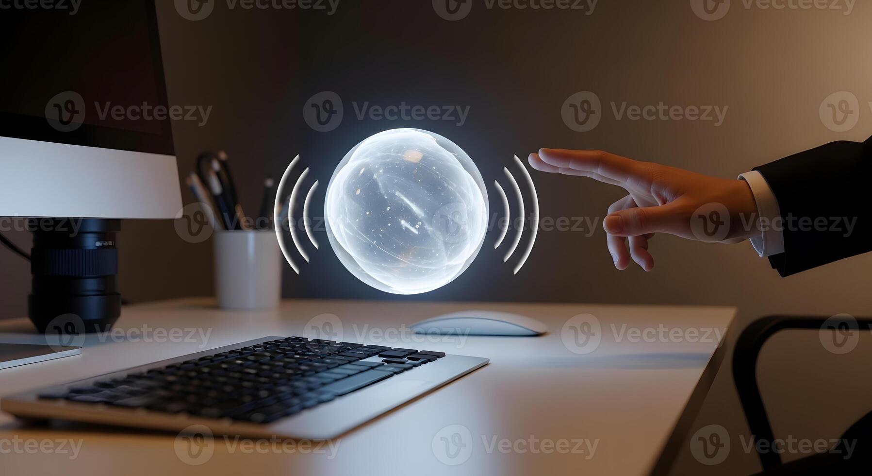 A person is touching a computer screen with a sphere on it photo