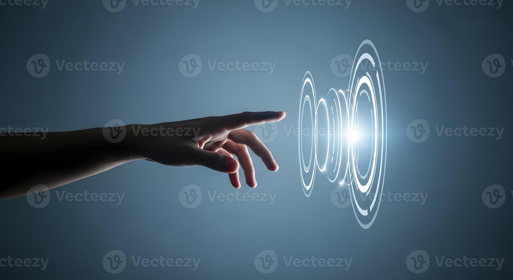 A hand touching a glowing circle on a dark background photo