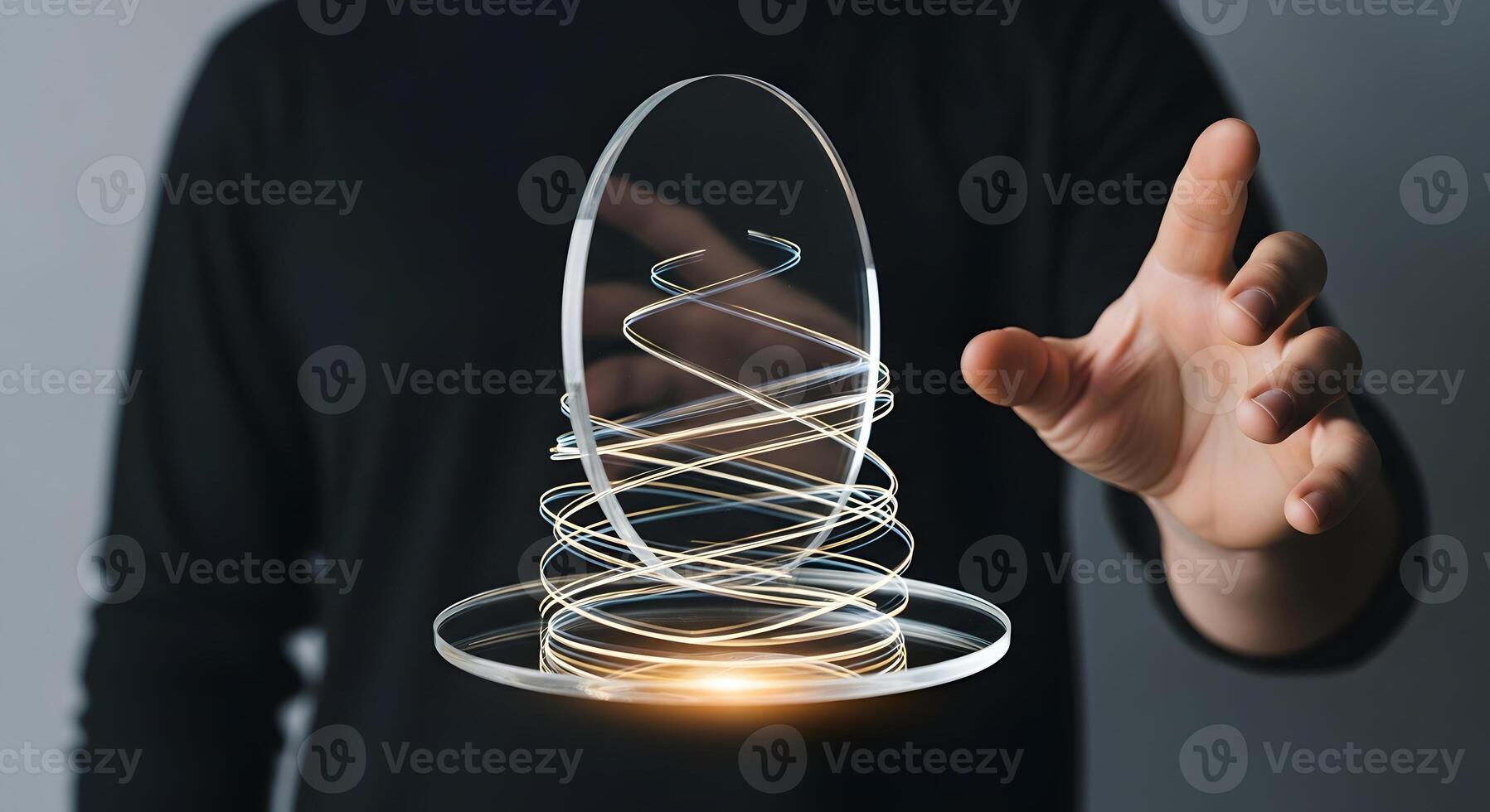 A person holding a glass sphere with a light coming out of it photo