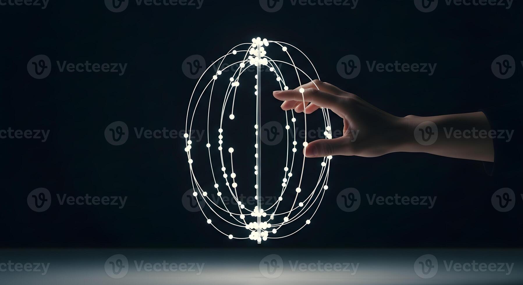A hand is holding a sphere with a line of dots photo