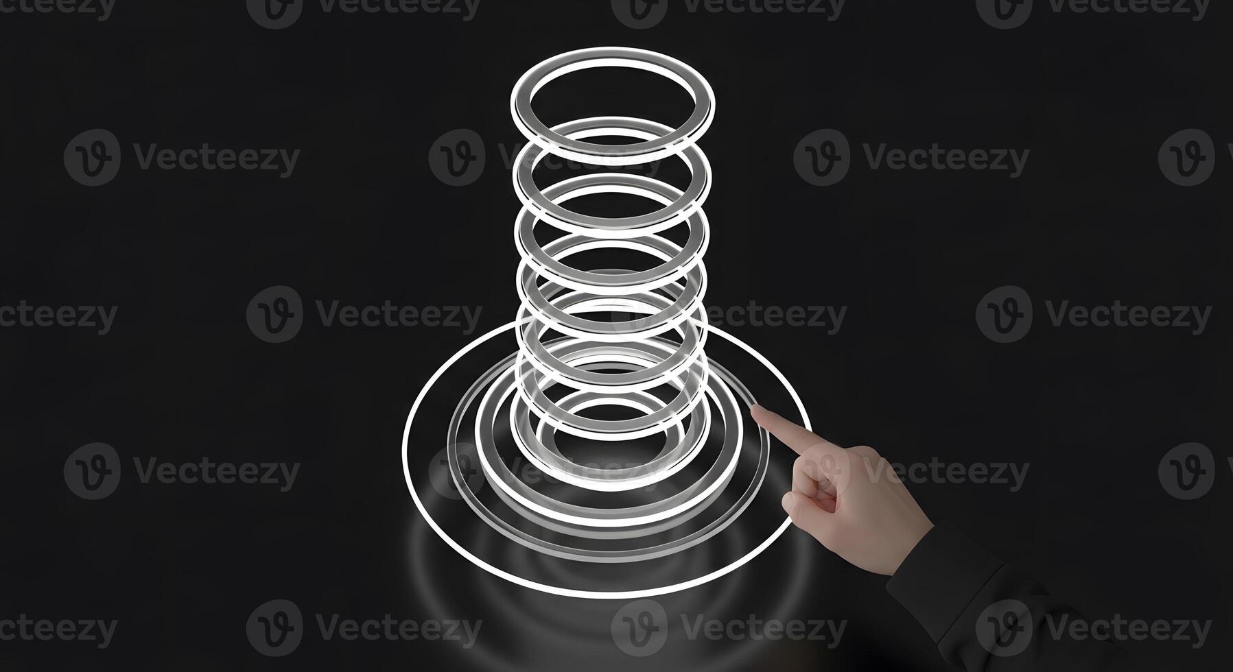 A person pointing at a ring of rings photo