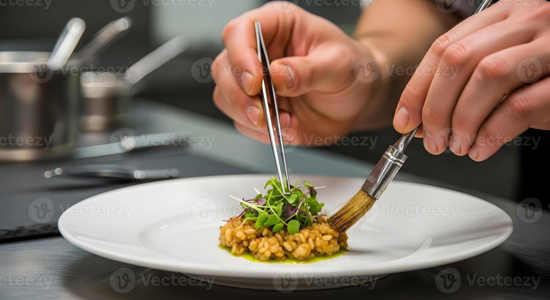 A chef is using a fork to stir food on a plate photo