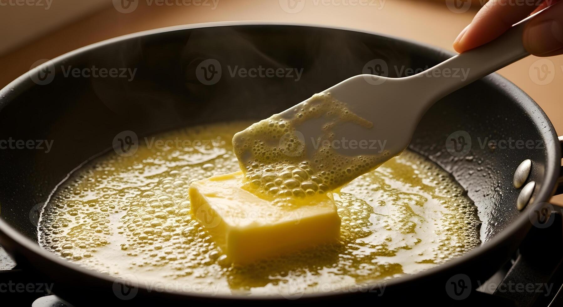 A person stirring butter into a pan photo