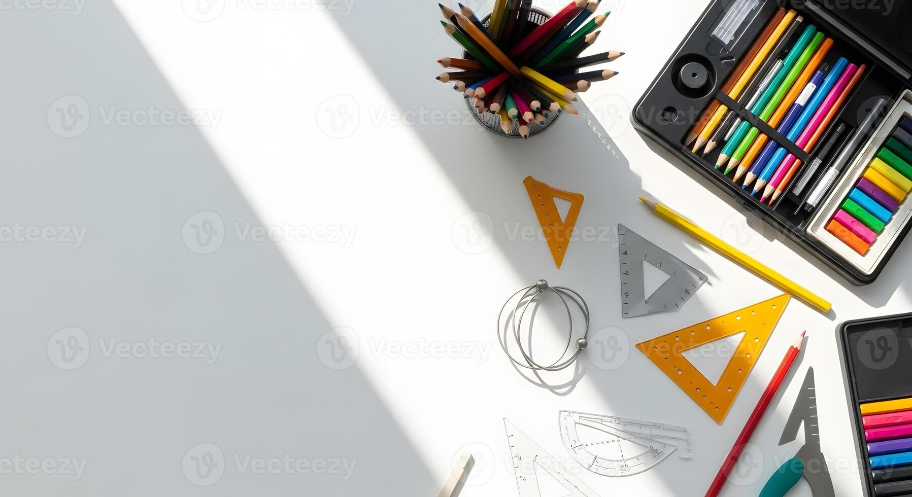 A table with a variety of supplies including pens, pencils, markers, and other items photo