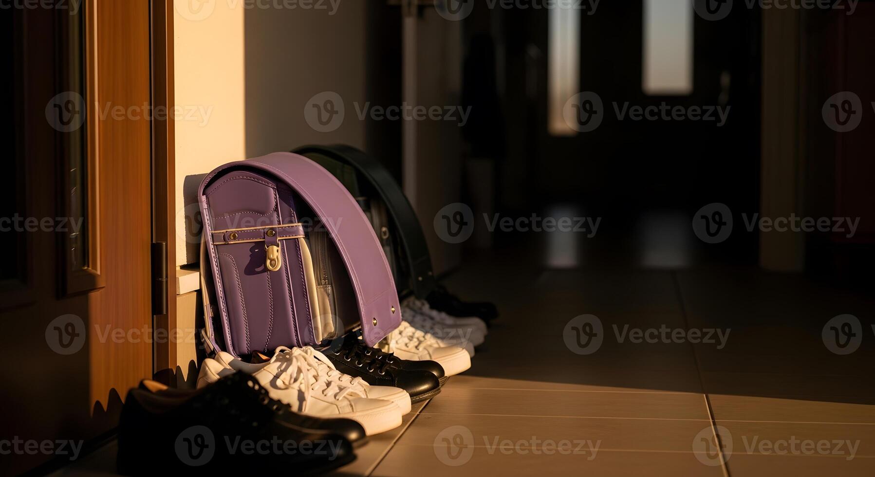 A row of shoes lined up on a tiled floor photo