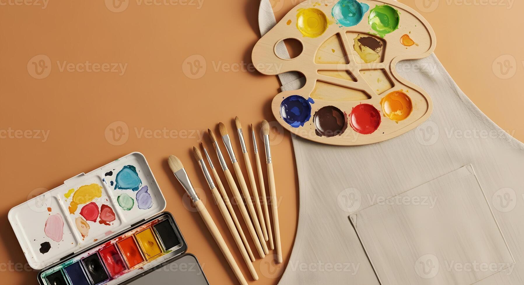 Apron, paint palette, brushes and paintbrushes on a table photo