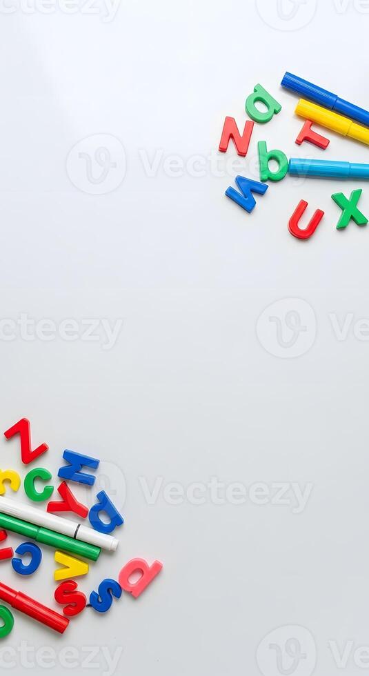 Colorful alphabet letters and pencils on a white surface photo